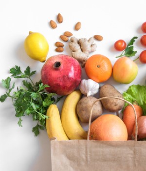 Picture of produce falling onto the counter from a paper bag. 